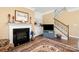 Inviting living room with a fireplace, built-in shelving, and staircase access at 17028 River Race Dr, Huntersville, NC 28078