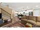 Open concept living room with staircase, kitchen view, and comfortable seating area at 17028 River Race Dr, Huntersville, NC 28078
