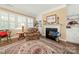 Cozy living room with fireplace, built-in shelving, and shuttered windows at 17028 River Race Dr, Huntersville, NC 28078