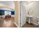 Powder room with pedestal sink, set off of an open dining room area, and hardwood flooring at 17028 River Race Dr, Huntersville, NC 28078