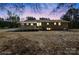 Backyard view of the house at dusk featuring a wheelchair ramp and access to outdoors at 174 Maske Rd, Mount Gilead, NC 27306