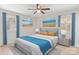 This is a staged bedroom with modern decor, large windows, and a ceiling fan at 174 Maske Rd, Mount Gilead, NC 27306
