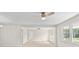 Bright living room with hardwood floors, natural light from large windows, and a ceiling fan at 174 Maske Rd, Mount Gilead, NC 27306