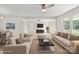 Open-concept living room with two sofas, a coffee table, hardwood floors, and natural light from large windows at 174 Maske Rd, Mount Gilead, NC 27306