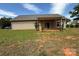 Spacious backyard featuring a covered patio and sliding glass doors, perfect for outdoor living and entertaining at 190 Watering Trough Rd, Statesville, NC 28677