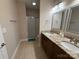 Bathroom features a double sink vanity, shower, and tiled flooring at 190 Watering Trough Rd, Statesville, NC 28677