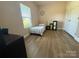 This bedroom features a window, closet and wood-look floors at 190 Watering Trough Rd, Statesville, NC 28677
