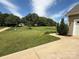 Well-manicured lawn and garden with trees at 190 Watering Trough Rd, Statesville, NC 28677