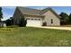 Angle view of a two car garage with light trim and an asphalt driveway at 190 Watering Trough Rd, Statesville, NC 28677