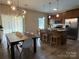 Charming kitchen and dining area with modern lighting, stainless appliances, and open concept layout at 190 Watering Trough Rd, Statesville, NC 28677