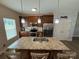 Spacious kitchen featuring granite countertops, stainless steel appliances, and modern lighting at 190 Watering Trough Rd, Statesville, NC 28677