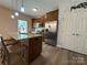 Kitchen with stainless steel appliances, island with seating, and a stylish pantry door at 190 Watering Trough Rd, Statesville, NC 28677