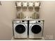 Convenient laundry room featuring modern washer and dryer with ample storage at 190 Watering Trough Rd, Statesville, NC 28677