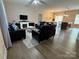 Open-concept living room with hardwood floors, a cozy fireplace, and abundant natural light at 190 Watering Trough Rd, Statesville, NC 28677