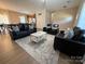 Open-concept living area showcasing stylish furnishings, a modern rug, and a well-lit dining area at 190 Watering Trough Rd, Statesville, NC 28677