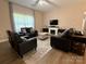 Comfortable living room featuring hardwood flooring, fireplace, and neutral wall tones at 190 Watering Trough Rd, Statesville, NC 28677