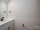 Half-bath featuring a white vanity, quartz countertop, and black hardware at 1941 32Nd Ne St, Hickory, NC 28601