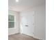 This bright bedroom has a closet featuring double doors with matte black hardware, and a bright window at 1941 32Nd Ne St, Hickory, NC 28601