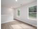 Light-filled bedroom with two windows featuring modern, gray floors, and neutral tones at 1941 32Nd Ne St, Hickory, NC 28601