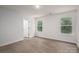 Sunny bedroom with light gray floors and a crisp white door to an ensuite bathroom at 1941 32Nd Ne St, Hickory, NC 28601