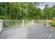 Outdoor deck surrounded by a white railing and green trees at 1941 32Nd Ne St, Hickory, NC 28601