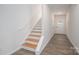 Bright entryway with hardwood stairs, gray flooring, and a white front door provides a welcoming first impression at 1941 32Nd Ne St, Hickory, NC 28601