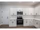 Modern kitchen with stainless steel appliances, white cabinets, and quartz countertops at 1941 32Nd Ne St, Hickory, NC 28601