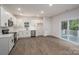 Bright modern kitchen features stainless steel appliances, white cabinets, and sliding glass door to deck at 1941 32Nd Ne St, Hickory, NC 28601