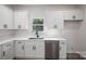 Bright kitchen featuring white cabinets, stainless steel appliances, and a window over the sink at 1941 32Nd Ne St, Hickory, NC 28601