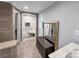 Bathroom featuring a modern, tiled shower with glass doors and bench, and large mirror at 204 N Gaston St, Kings Mountain, NC 28086