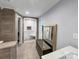 Bathroom featuring a modern, tiled shower with glass doors and bench, and large mirror at 204 N Gaston St, Kings Mountain, NC 28086