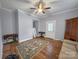 Open living area with hardwood floors, ceiling fan and access to outside at 204 N Gaston St, Kings Mountain, NC 28086