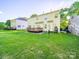 Lush backyard with a well-manicured lawn, mature trees, offering privacy and outdoor enjoyment at 2111 Elendil Ln, Charlotte, NC 28269