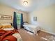 Cozy bedroom featuring twin beds, a neutral color scheme, and a window, ideal for children or guests at 2111 Elendil Ln, Charlotte, NC 28269