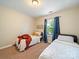 Bright bedroom with two twin beds, a window letting in natural light and neutral walls, perfect for or guests at 2111 Elendil Ln, Charlotte, NC 28269
