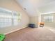 Spacious bonus room with carpet flooring, natural light and ample space for activities at 2111 Elendil Ln, Charlotte, NC 28269