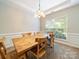 Dining room with a wooden table, decorative chandelier and carpeted flooring at 2111 Elendil Ln, Charlotte, NC 28269