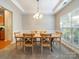 Dining room with wood table, pendant lighting, and large window at 2111 Elendil Ln, Charlotte, NC 28269