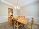 An expansive dining room features a long wooden table, decorative molding and a window at 2111 Elendil Ln, Charlotte, NC 28269
