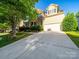 Charming two-story home with a well-maintained lawn, two car garage and mature trees at 2111 Elendil Ln, Charlotte, NC 28269