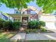 Beautiful two-story home with brick accents, a covered front porch, and lush landscaping at 2111 Elendil Ln, Charlotte, NC 28269