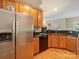 Spacious kitchen with stainless steel appliances, wood cabinets, and hardwood floors at 2111 Elendil Ln, Charlotte, NC 28269