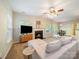 Bright living room featuring a fireplace, ceiling fan, and comfortable neutral colored sofa at 2111 Elendil Ln, Charlotte, NC 28269