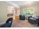 Inviting living room with large window, stylish chairs, patterned rug, and view into the dining room at 2111 Elendil Ln, Charlotte, NC 28269