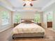 Spacious main bedroom with a large bed, bedside tables, and multiple windows for natural light, creating a serene atmosphere at 2111 Elendil Ln, Charlotte, NC 28269