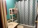 Well-lit bathroom featuring a shower/tub combo with a patterned shower curtain at 2165 Peanuts Ln, Newton, NC 28658