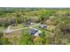 Aerial view of homes in a wooded area with large lawns and mature trees at 2458 Genelia Dr, Claremont, NC 28610