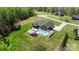 Aerial view of a brick home with a pool, a covered patio, and a well-manicured lawn at 2458 Genelia Dr, Claremont, NC 28610