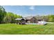 This backyard features a pool, covered patio with fireplace, and fenced in yard at 2458 Genelia Dr, Claremont, NC 28610