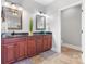 Well-lit bathroom with dual sinks, granite countertops, and wood cabinetry at 2458 Genelia Dr, Claremont, NC 28610